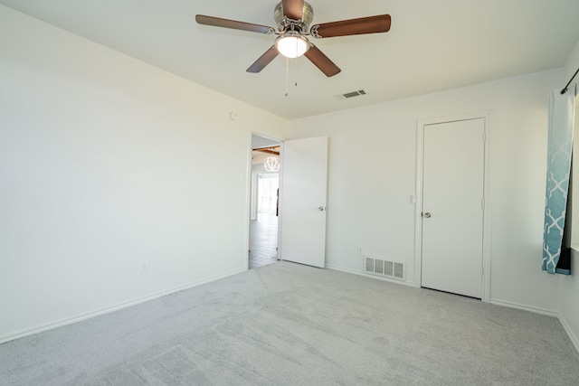 unfurnished bedroom featuring light colored carpet and ceiling fan