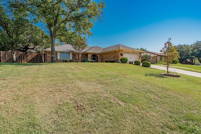 ranch-style home with a garage and a front yard