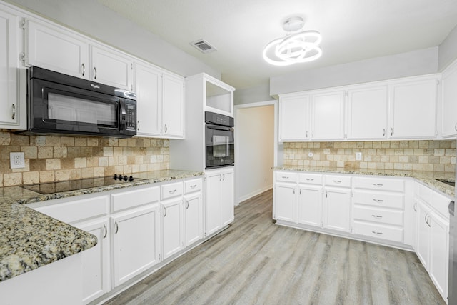 kitchen with black appliances, light hardwood / wood-style flooring, and white cabinetry