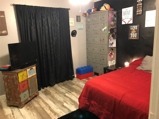 bedroom with hardwood / wood-style flooring and a closet