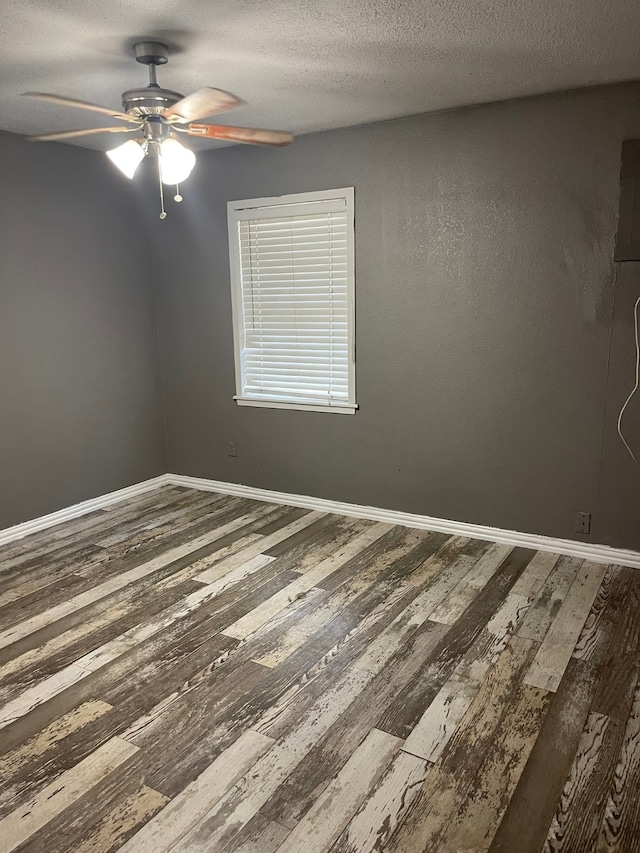 unfurnished room with hardwood / wood-style flooring, ceiling fan, and a textured ceiling