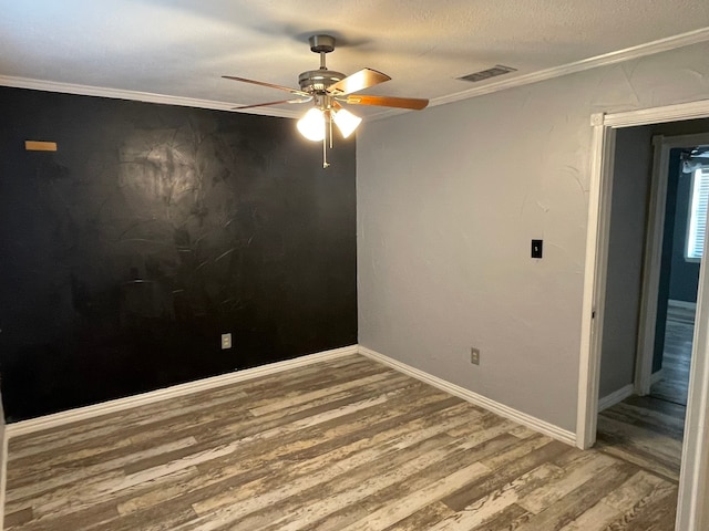 unfurnished room with wood-type flooring, a textured ceiling, ornamental molding, and ceiling fan