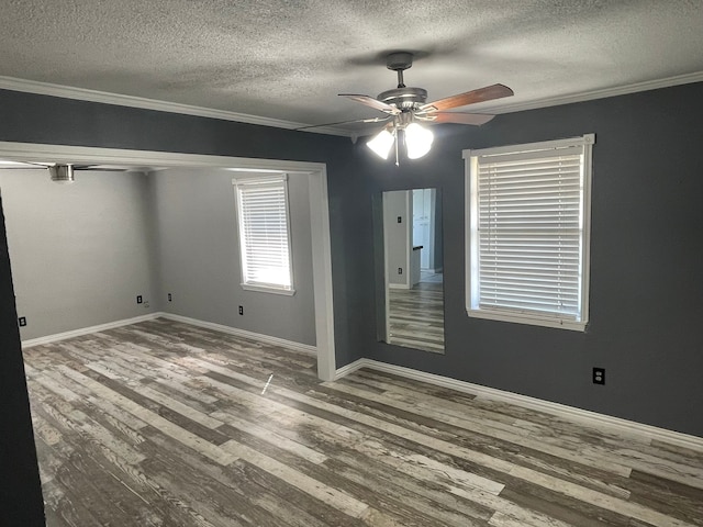 unfurnished bedroom with wood-type flooring, ornamental molding, a textured ceiling, and ceiling fan