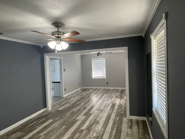 spare room featuring ceiling fan, dark hardwood / wood-style floors, and ornamental molding