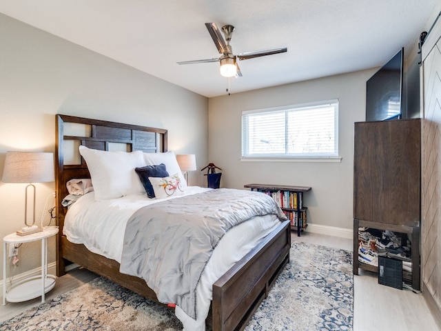 bedroom featuring hardwood / wood-style floors and ceiling fan