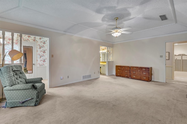 living area with crown molding, a textured ceiling, and light carpet