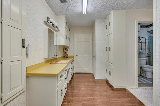 mudroom featuring hardwood / wood-style floors and a textured ceiling