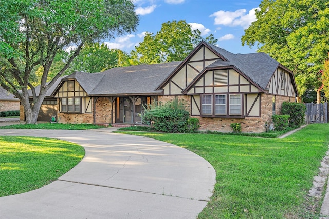 english style home featuring a front lawn