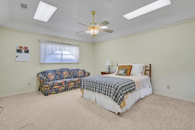 carpeted bedroom with ceiling fan and ornamental molding