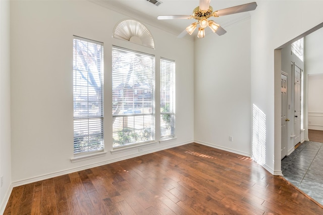 spare room with ceiling fan, dark hardwood / wood-style floors, and ornamental molding