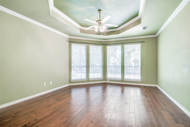 spare room featuring a raised ceiling, ceiling fan, wood-type flooring, and ornamental molding