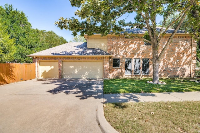 view of front of property featuring a garage and a front yard