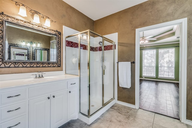 bathroom featuring vanity, an enclosed shower, and ceiling fan