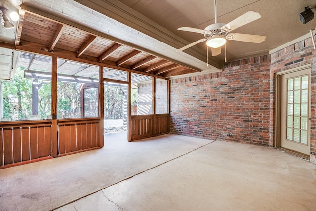 unfurnished sunroom with ceiling fan, beamed ceiling, and wood ceiling