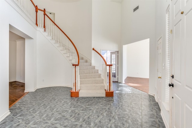 tiled entryway with a high ceiling