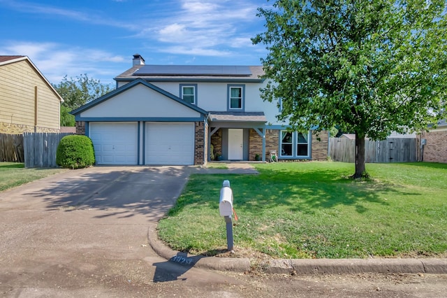 view of front property with a front lawn, a garage, and solar panels