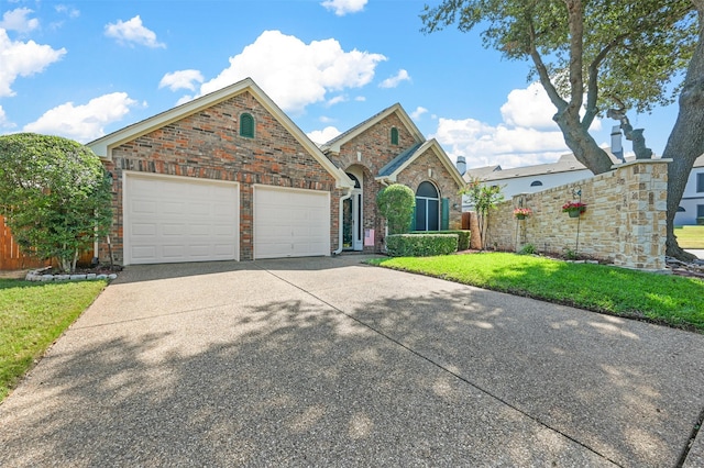 front of property featuring a garage and a front lawn