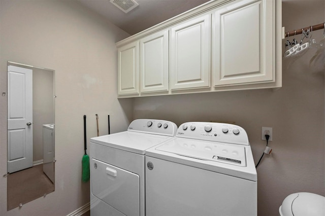 laundry room featuring cabinets and washer and dryer