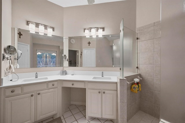 bathroom with vanity, tile patterned flooring, and tiled shower