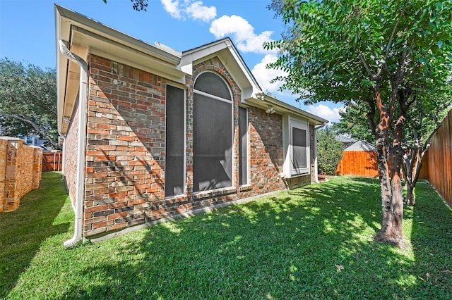 rear view of house featuring a lawn