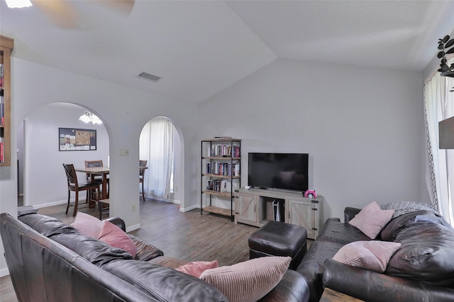 living room featuring lofted ceiling and hardwood / wood-style floors