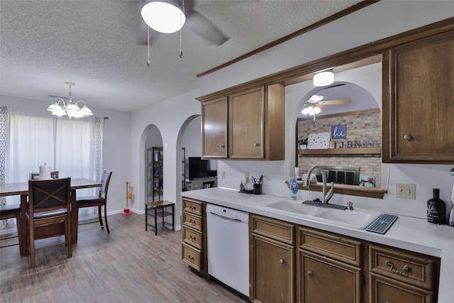 kitchen featuring dishwasher, light hardwood / wood-style floors, sink, and a textured ceiling