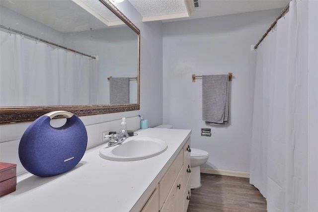 bathroom with hardwood / wood-style floors, vanity, and toilet