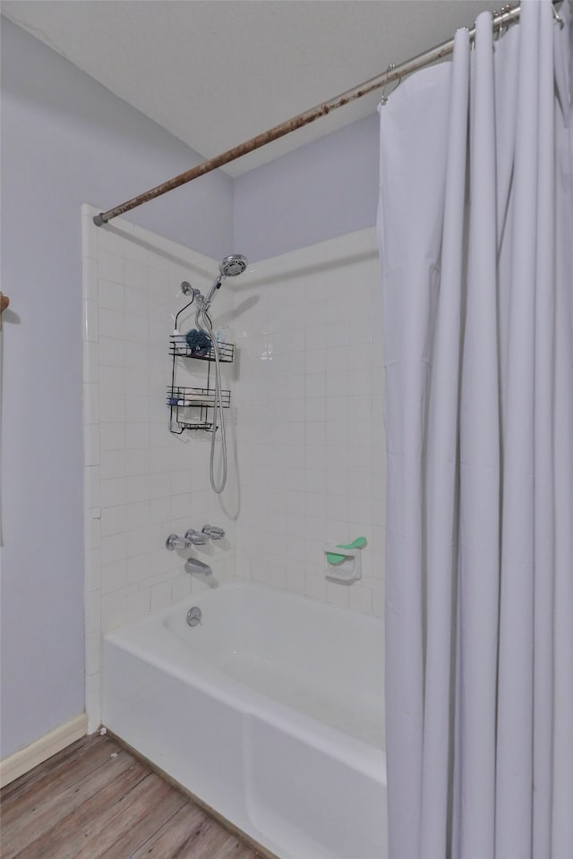 bathroom featuring shower / tub combo and hardwood / wood-style floors