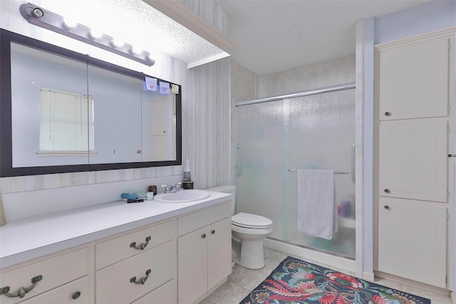 bathroom with tile patterned floors, vanity, walk in shower, and toilet