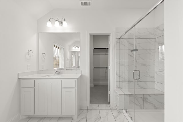 bathroom with vanity, lofted ceiling, and an enclosed shower