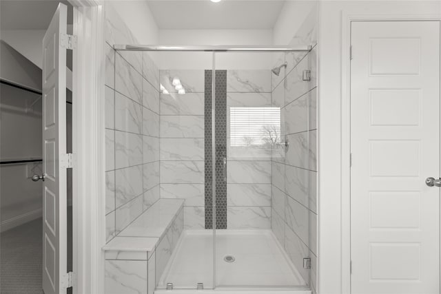 bathroom featuring a shower with shower door