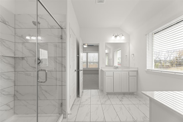 bathroom featuring lofted ceiling, vanity, a shower with door, and ceiling fan