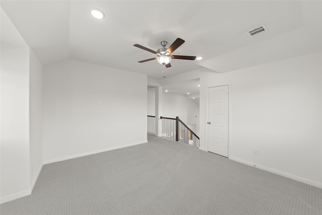 carpeted empty room with ceiling fan and lofted ceiling