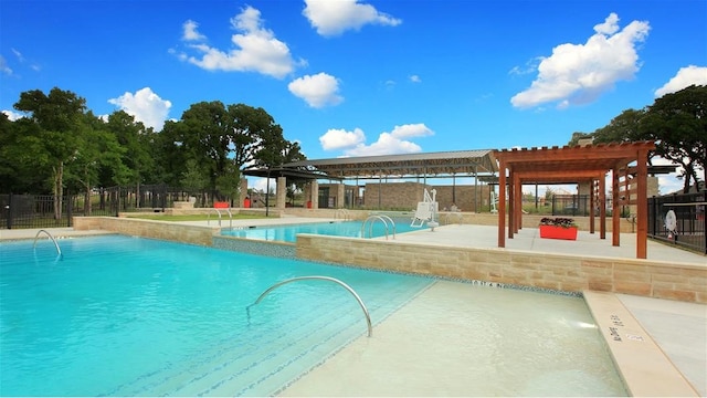 view of swimming pool featuring a patio area and a pergola