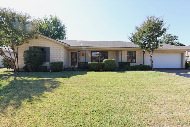 ranch-style home featuring a garage and a front yard