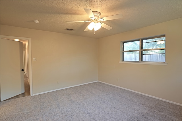 empty room with a textured ceiling, ceiling fan, and carpet floors