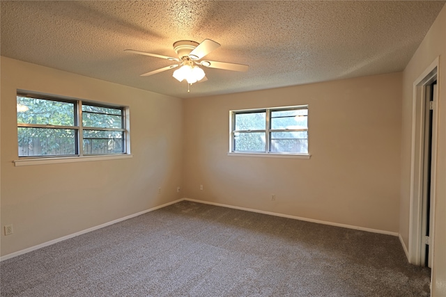 carpeted spare room with a textured ceiling and ceiling fan