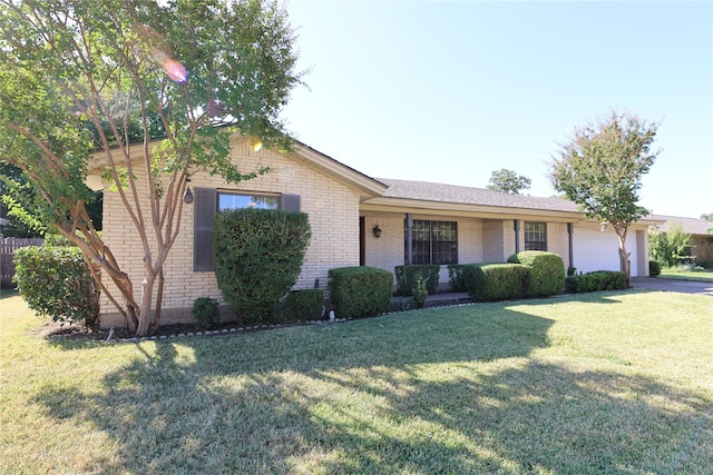 ranch-style home featuring a garage and a front lawn