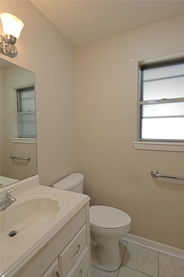 bathroom featuring toilet, tile patterned flooring, and vanity