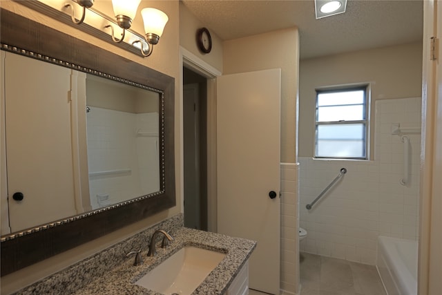 bathroom with toilet, vanity, and a textured ceiling