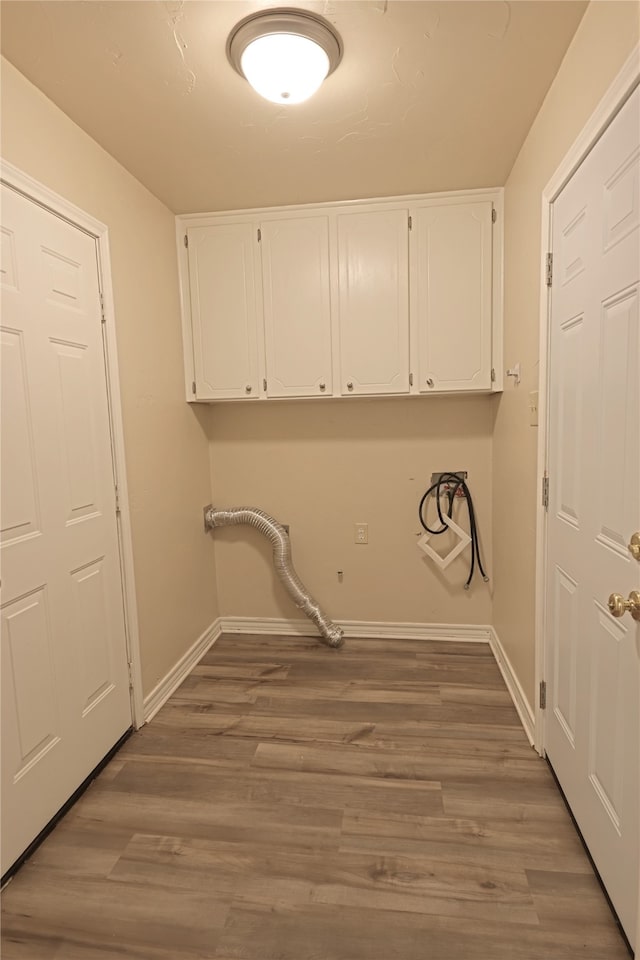 laundry room with cabinets, dark hardwood / wood-style floors, and hookup for a washing machine