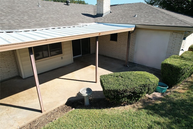 back of house featuring a carport