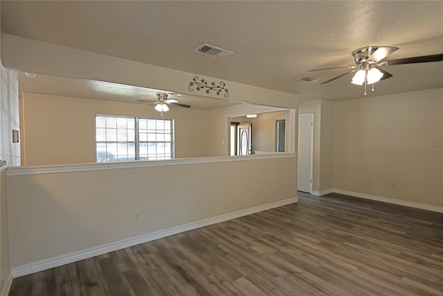 spare room featuring ceiling fan and dark hardwood / wood-style floors