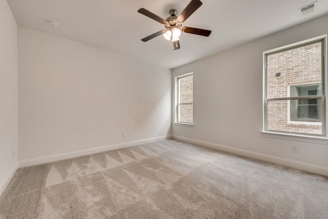 unfurnished room with ceiling fan and light colored carpet