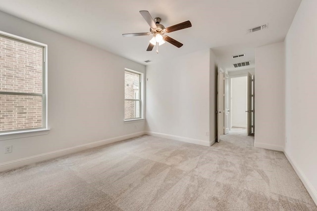 unfurnished room featuring ceiling fan and light colored carpet