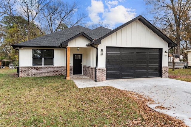 view of front of home with a garage and a front lawn