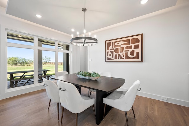 dining room with recessed lighting, a notable chandelier, baseboards, and wood finished floors