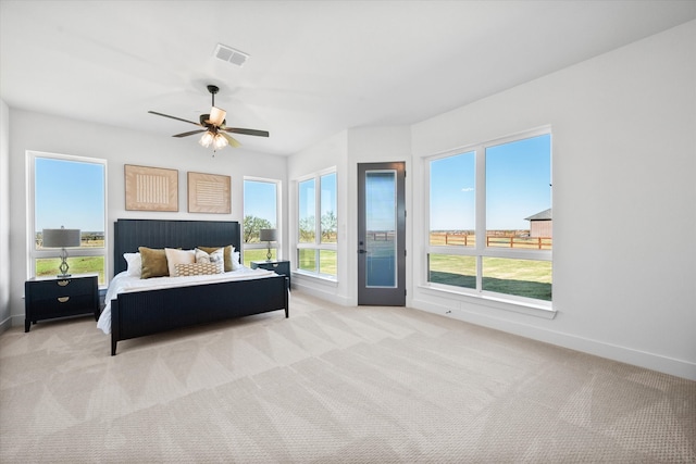 bedroom with visible vents, baseboards, a ceiling fan, light colored carpet, and access to outside