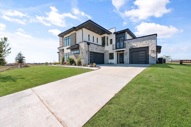 contemporary house featuring a balcony, stone siding, driveway, and a front yard