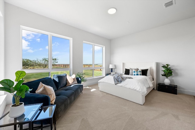 carpeted bedroom with visible vents and baseboards